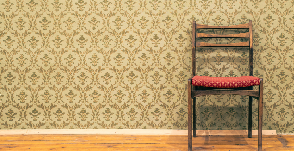 Grandma Chic interior design with vintage chair and wallpaper